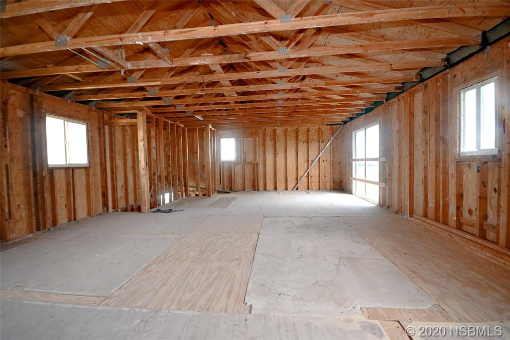 6829 Turtlemound Road New Smyrna Beach, FL 32169 - Photo 27 of 38 a view of an empty room with windows