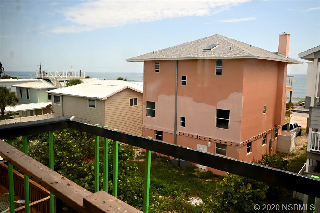 6829 Turtlemound Road New Smyrna Beach, FL 32169 - Photo 29 of 38 a large white building with a white roof deck