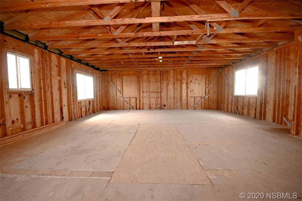 6829 Turtlemound Road New Smyrna Beach, FL 32169 - Photo 30 of 38 an empty room with windows