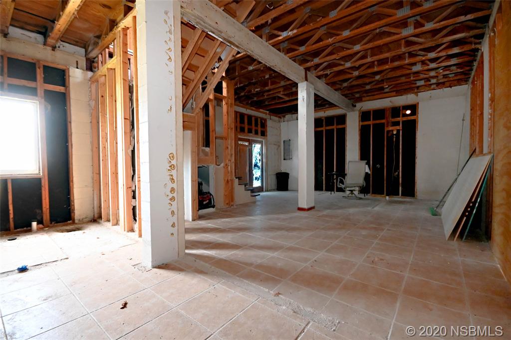 6829 Turtlemound Road New Smyrna Beach, FL 32169 - Photo 10 of 38 a view of a hallway with wooden floor