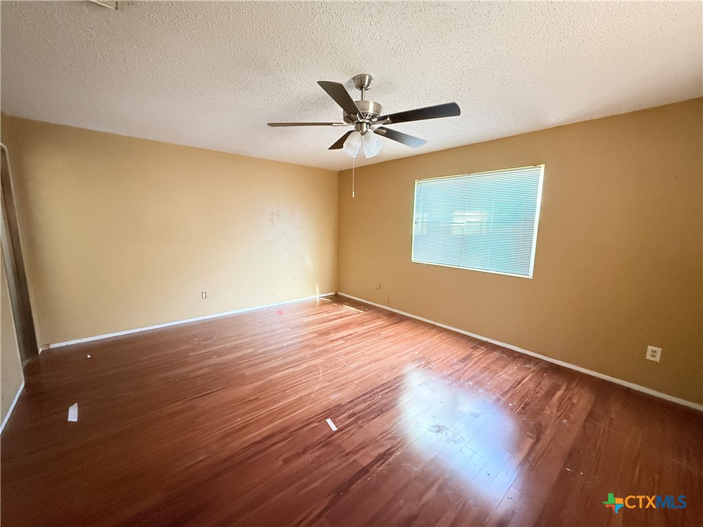 4700 Old Howard Road Temple, TX 76504 - Photo 13 of 33 an empty room with wooden floor and windows