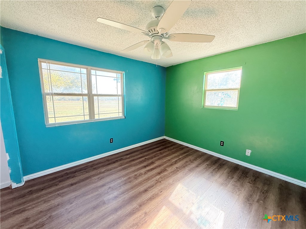 4700 Old Howard Road Temple, TX 76504 - Photo 18 of 33 a view of a room with window ceiling fan and hardwood floor