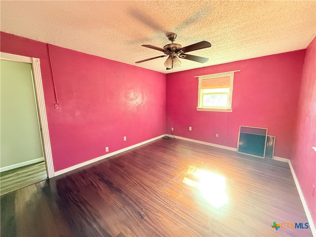 4700 Old Howard Road Temple, TX 76504 - Photo 25 of 33 a view of a room with wooden floor and a ceiling fan