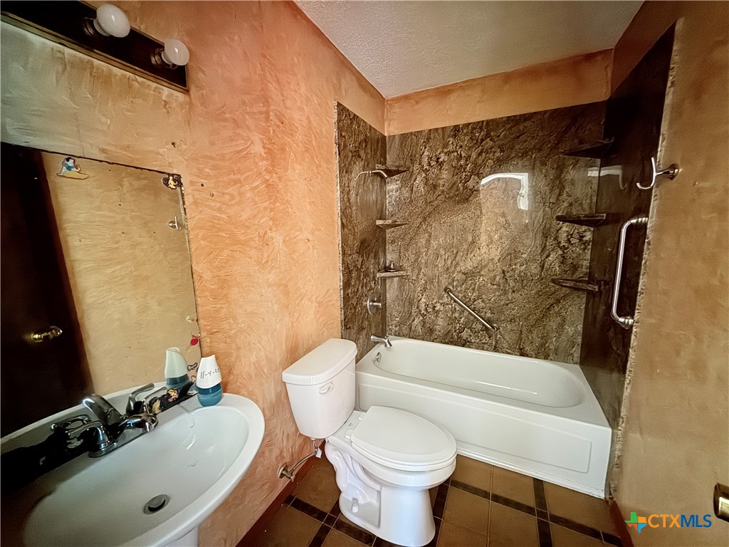 4700 Old Howard Road Temple, TX 76504 - Photo 26 of 33 a bathroom with a sink toilet and shower