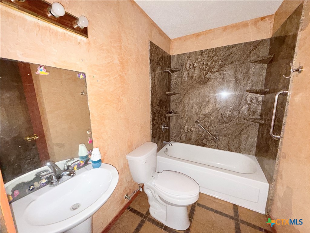 4700 Old Howard Road Temple, TX 76504 - Photo 27 of 33 a bathroom with a sink toilet and shower