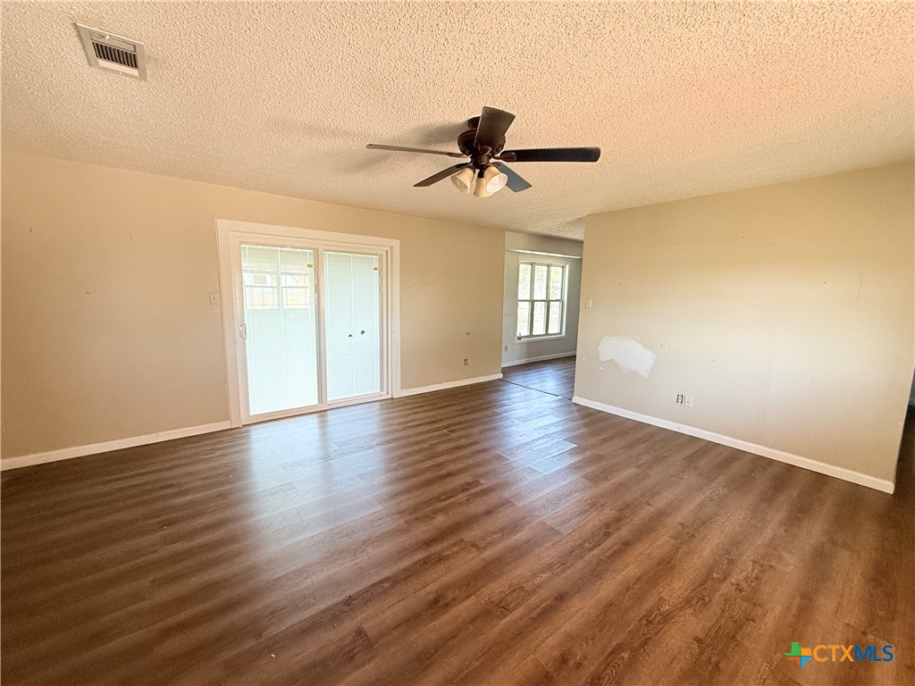 4700 Old Howard Road Temple, TX 76504 - Photo 4 of 33 an empty room with wooden floor and windows