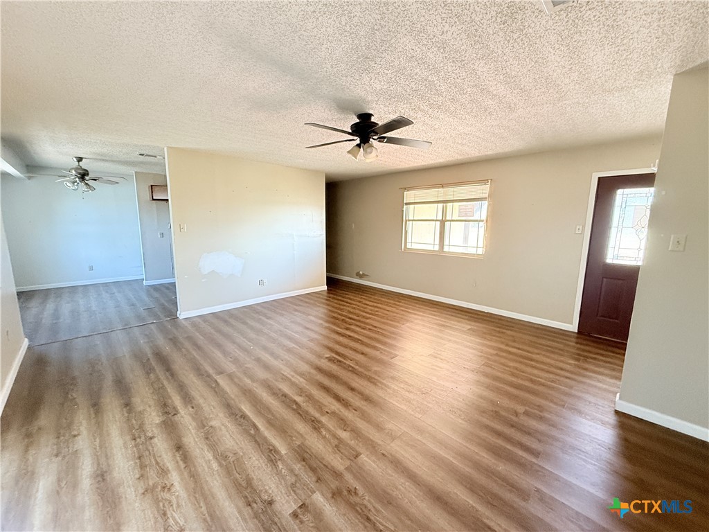 4700 Old Howard Road Temple, TX 76504 - Photo 5 of 33 wooden floor in an empty room with a window