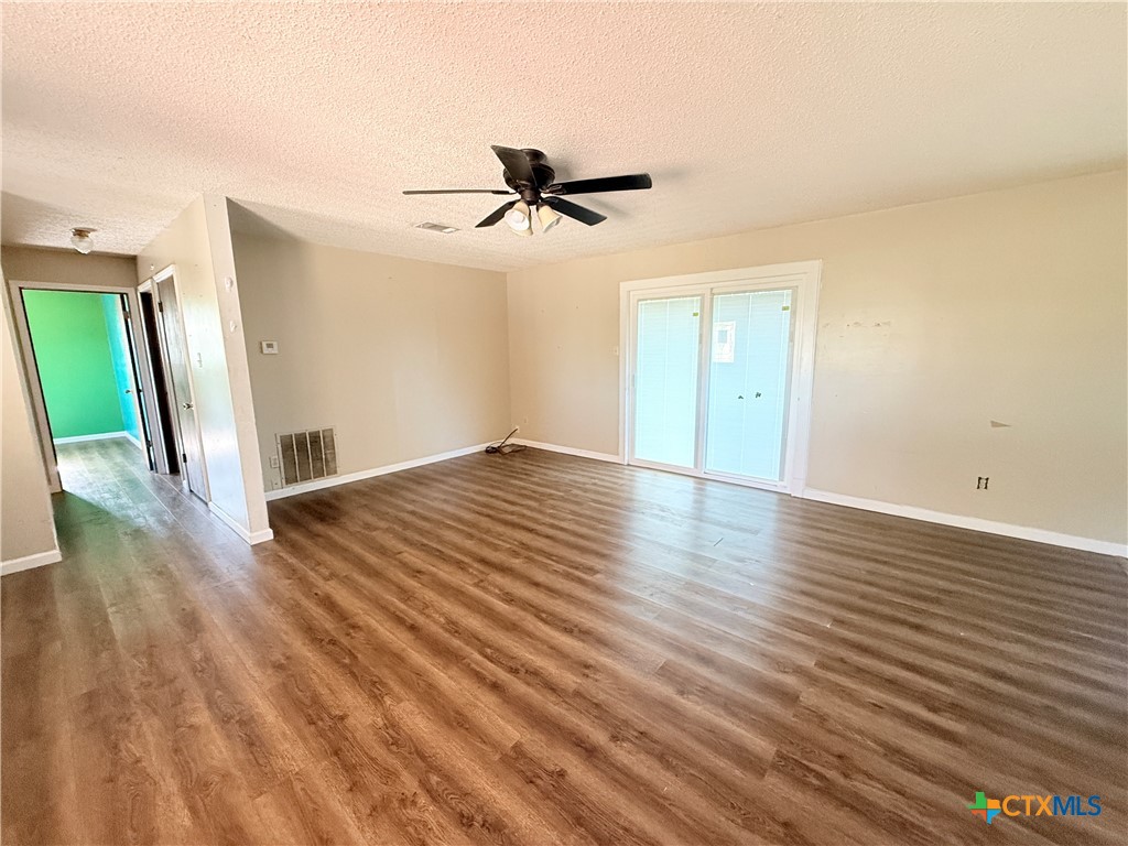 4700 Old Howard Road Temple, TX 76504 - Photo 7 of 33 a view of empty room with wooden floor and fan