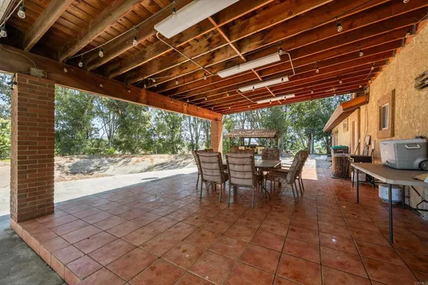 a view of a porch with furniture and a yard