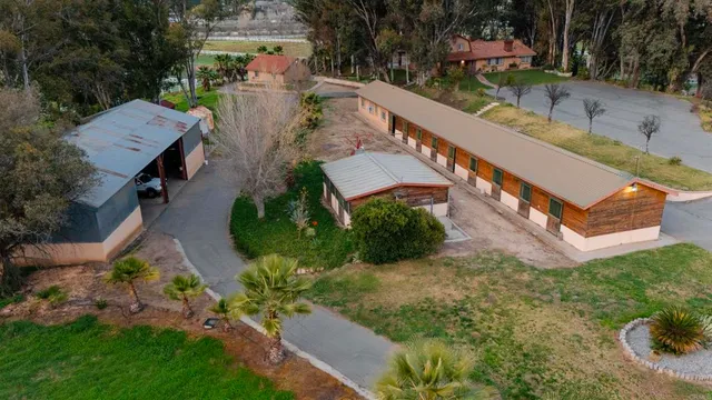 an aerial view of a house with a yard