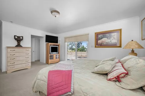 a bedroom with a bed and dresser