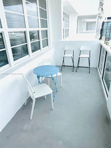 a view of a room with a table and chairs