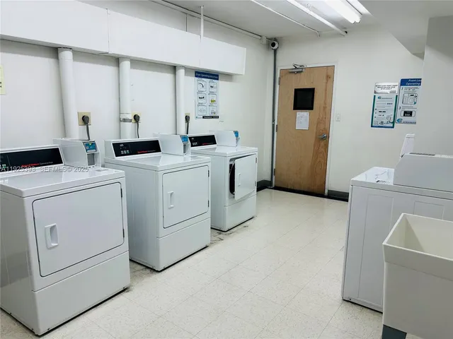 a view of storage and utility room with two washing machine
