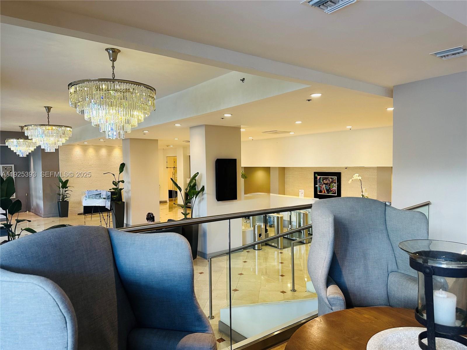 100 Lincoln Road, Unit 1427 Miami Beach, FL 33139 - Photo 6 of 30 a living room with furniture and a chandelier