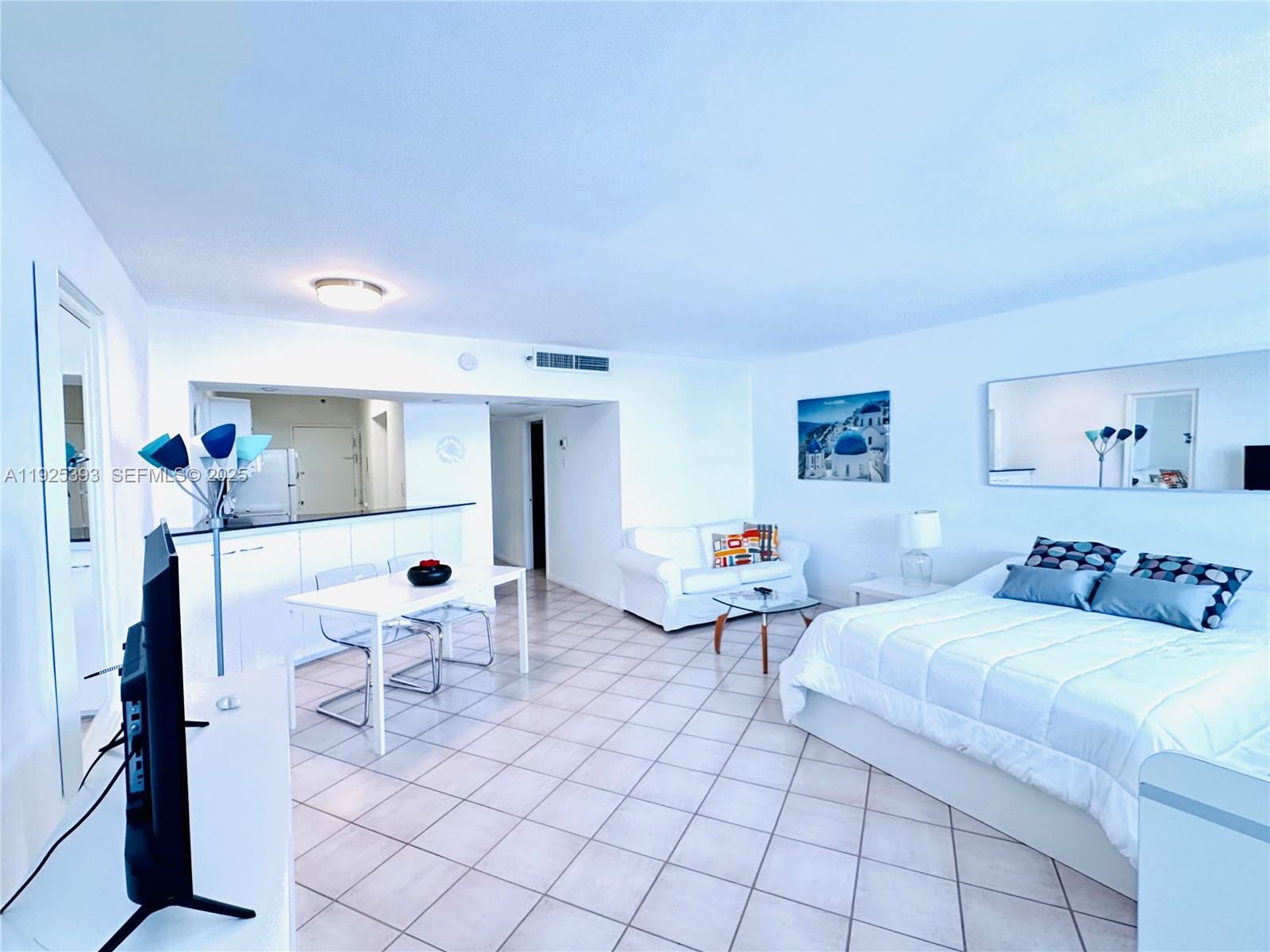 100 Lincoln Road, Unit 1427 Miami Beach, FL 33139 - Photo 8 of 30 a bedroom with 2 bed and a lamp on table