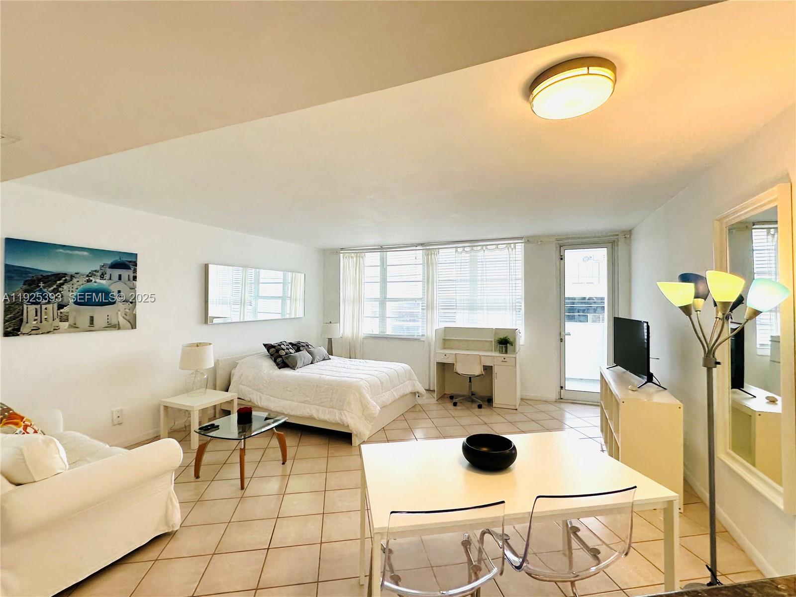 100 Lincoln Road, Unit 1427 Miami Beach, FL 33139 - Photo 9 of 30 a living room with furniture and wooden floor