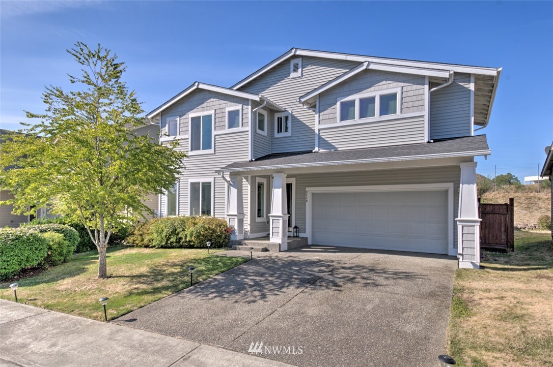 3114 Southeast 3rd Street Renton, WA 98056 - Photo 2 of 25 a front view of a house with a yard and garage