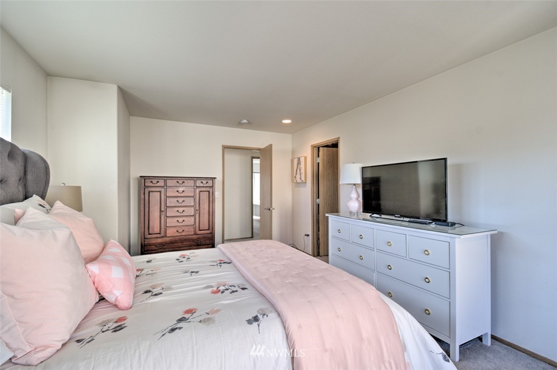 3114 Southeast 3rd Street Renton, WA 98056 - Photo 18 of 25 a bedroom with a large bed and a flat screen tv