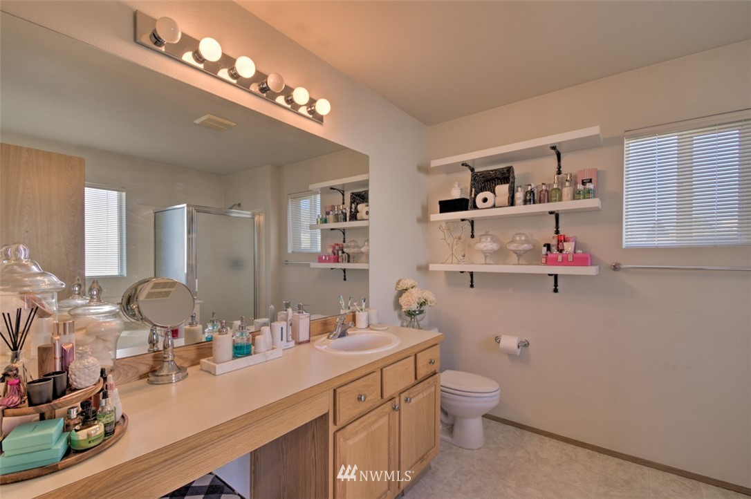 3114 Southeast 3rd Street Renton, WA 98056 - Photo 20 of 25 a bathroom with a double vanity sink a toilet and a mirror