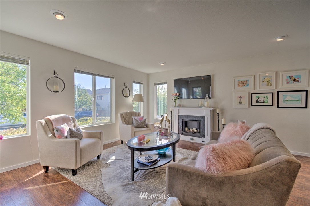 3114 Southeast 3rd Street Renton, WA 98056 - Photo 3 of 25 a living room with furniture a fireplace and a large window