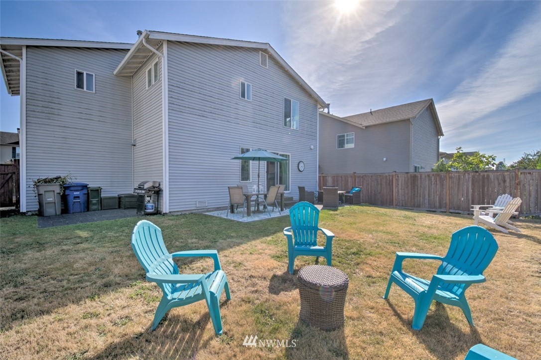 3114 Southeast 3rd Street Renton, WA 98056 - Photo 24 of 25 a view of a backyard with table and chairs potted plants and wooden fence