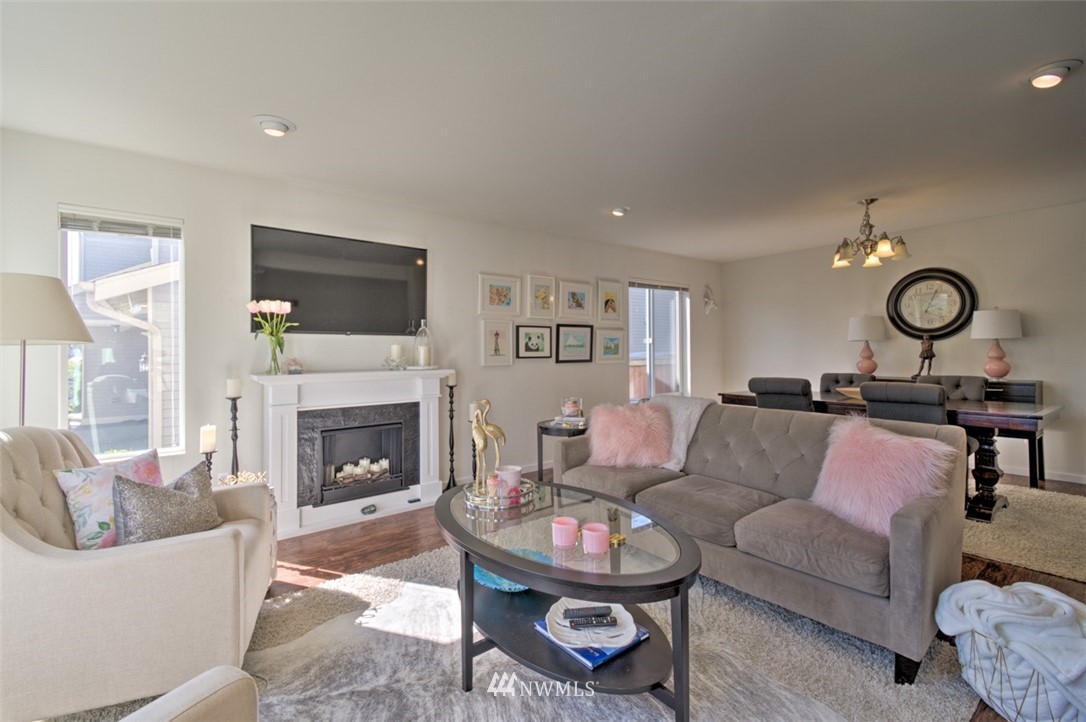 3114 Southeast 3rd Street Renton, WA 98056 - Photo 4 of 25 a living room with furniture a fireplace and a flat screen tv