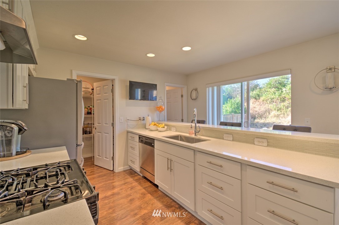 3114 Southeast 3rd Street Renton, WA 98056 - Photo 6 of 25 a kitchen with a sink stove and refrigerator
