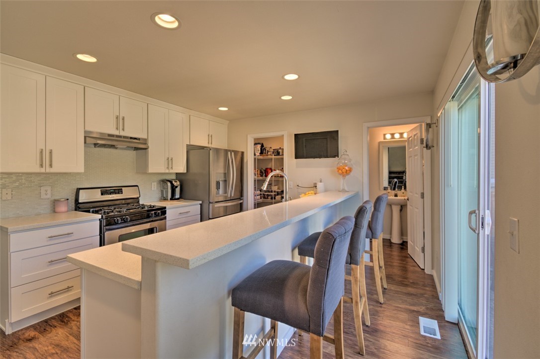 3114 Southeast 3rd Street Renton, WA 98056 - Photo 9 of 25 a kitchen with a refrigerator a stove top oven a sink and cabinets