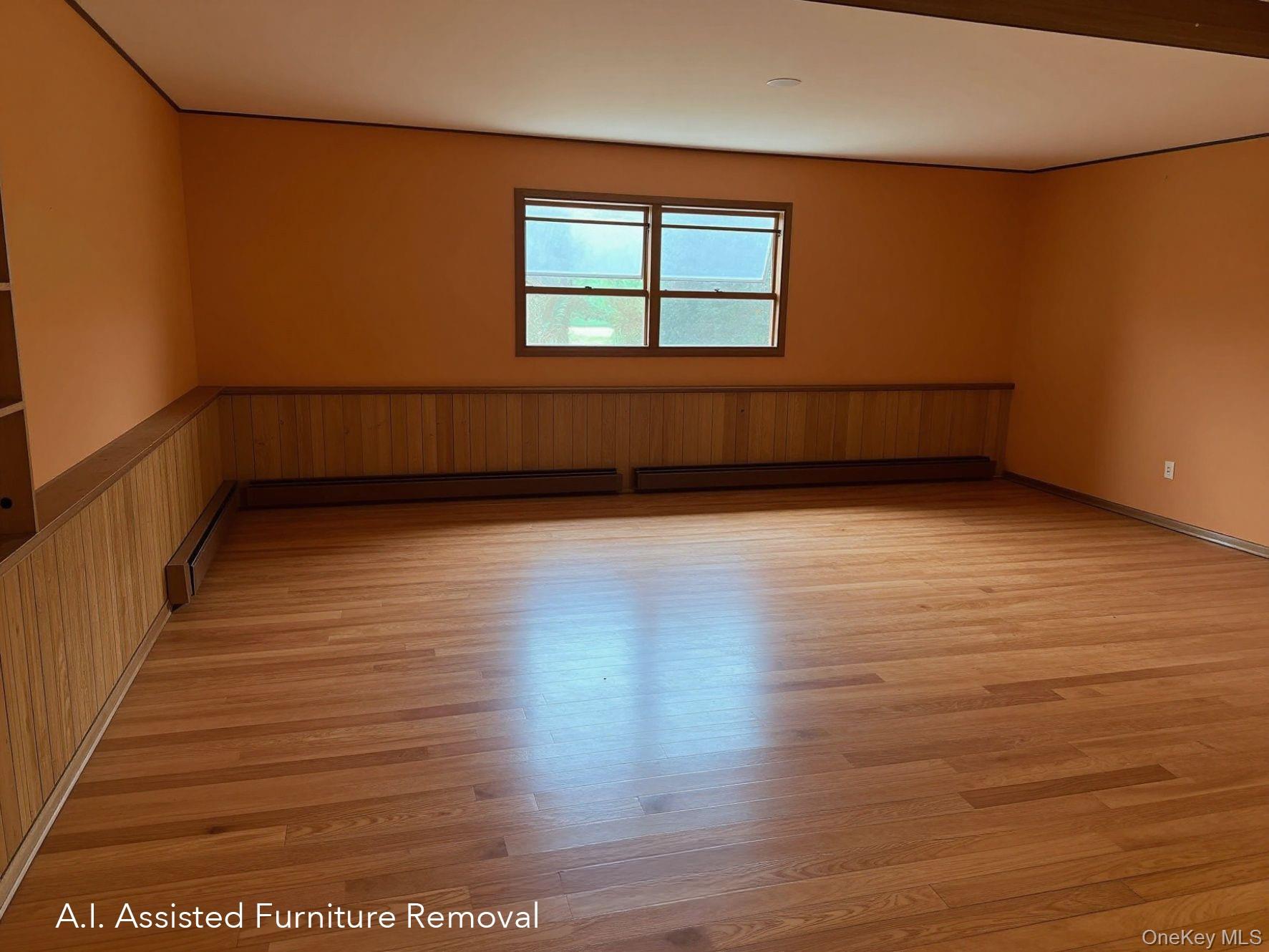94 Booth Road Chester, NY 10918 - Photo 15 of 21 Spacious first floor room featuring hard wood flooring, wood paneling, and a large window