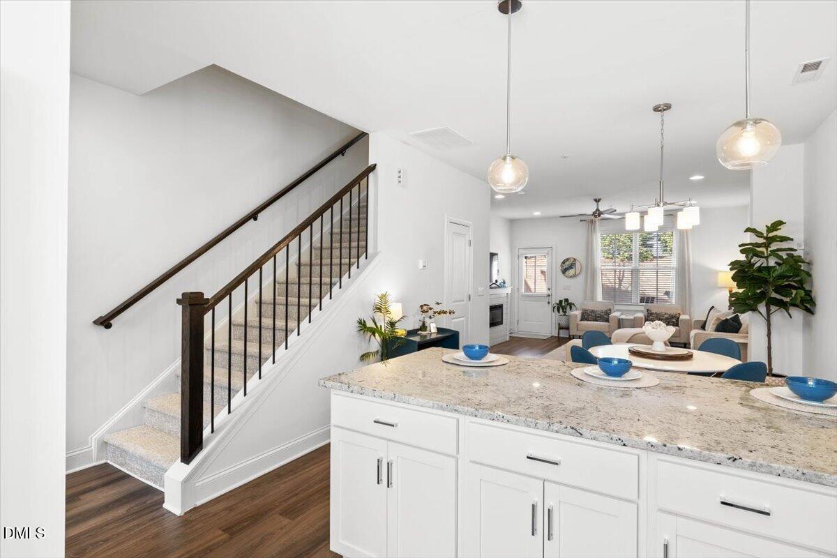 6810 Milligan Way, Unit 103 Raleigh, NC 27613 - Photo 12 of 37 a kitchen with sink and a wooden floor