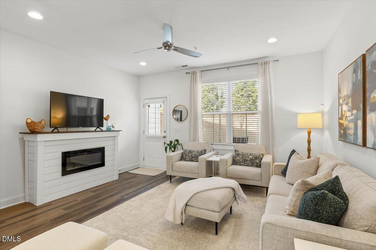 6810 Milligan Way, Unit 103 Raleigh, NC 27613 - Photo 17 of 37 a living room with furniture and a fireplace