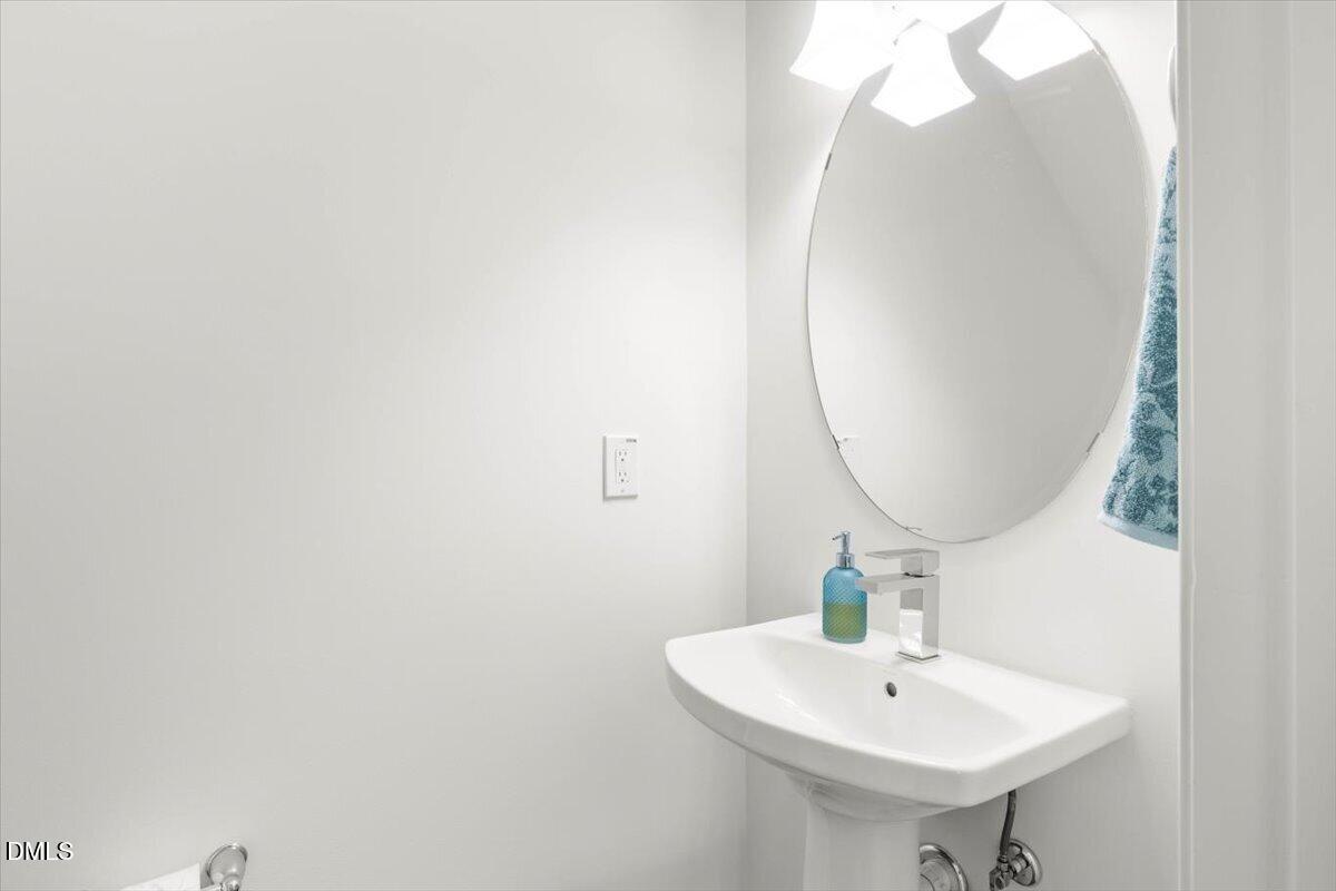 6810 Milligan Way, Unit 103 Raleigh, NC 27613 - Photo 21 of 37 a bathroom with a sink and a mirror