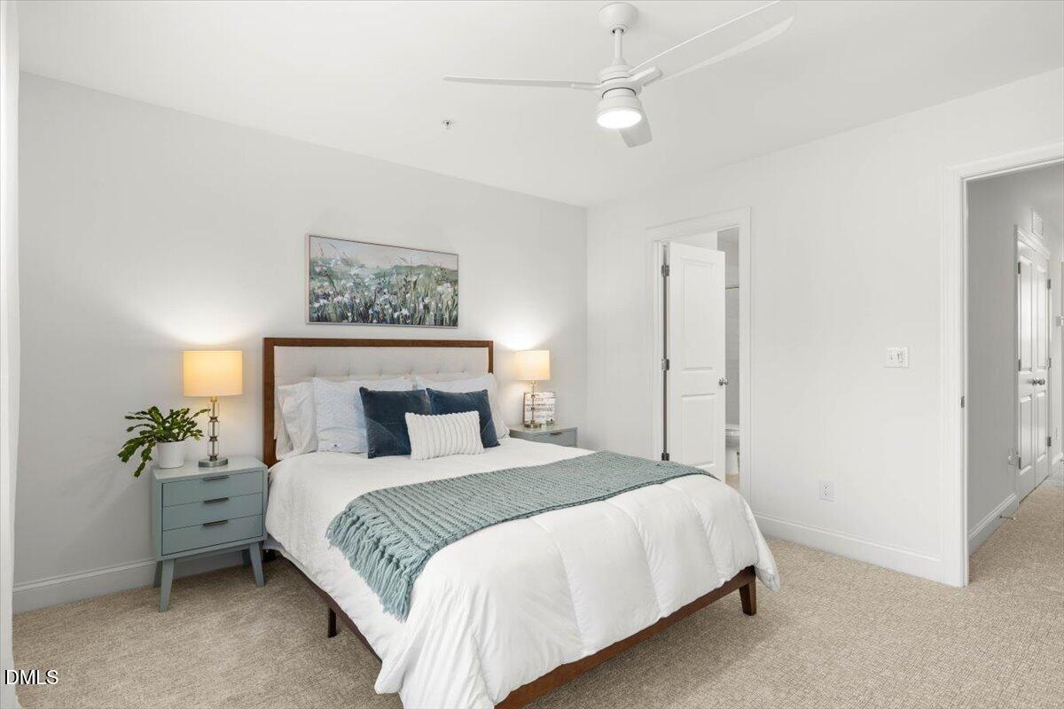 6810 Milligan Way, Unit 103 Raleigh, NC 27613 - Photo 23 of 37 a bedroom with a bed and a painting on the wall