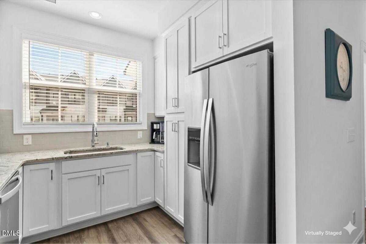 6810 Milligan Way, Unit 103 Raleigh, NC 27613 - Photo 8 of 37 a kitchen with a refrigerator sink and cabinets