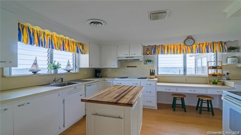 10 Weston Road Groton, CT 06340 - Photo 11 of 37 a kitchen with a sink stove and cabinets