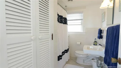 a bedroom with a bed and a lamp on window