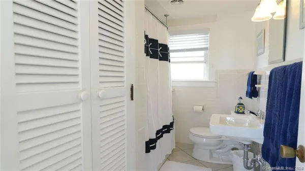 a bedroom with a bed and a lamp on window