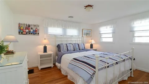 a bedroom with furniture and a window