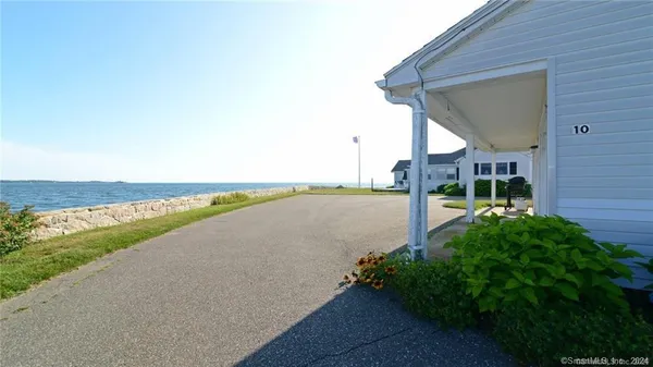 a view of a lake with a beach and a big yard