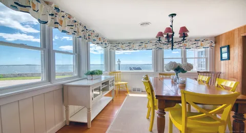 a very nice looking dining room with a large window