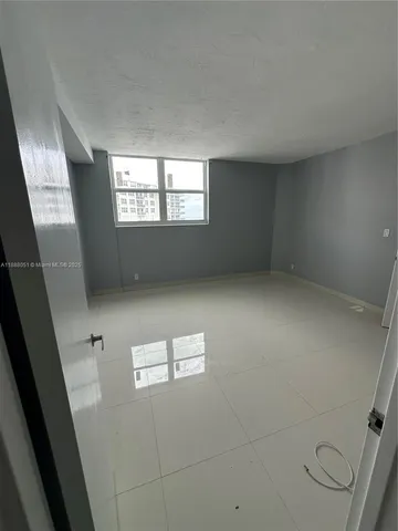 an empty room with windows and entrance