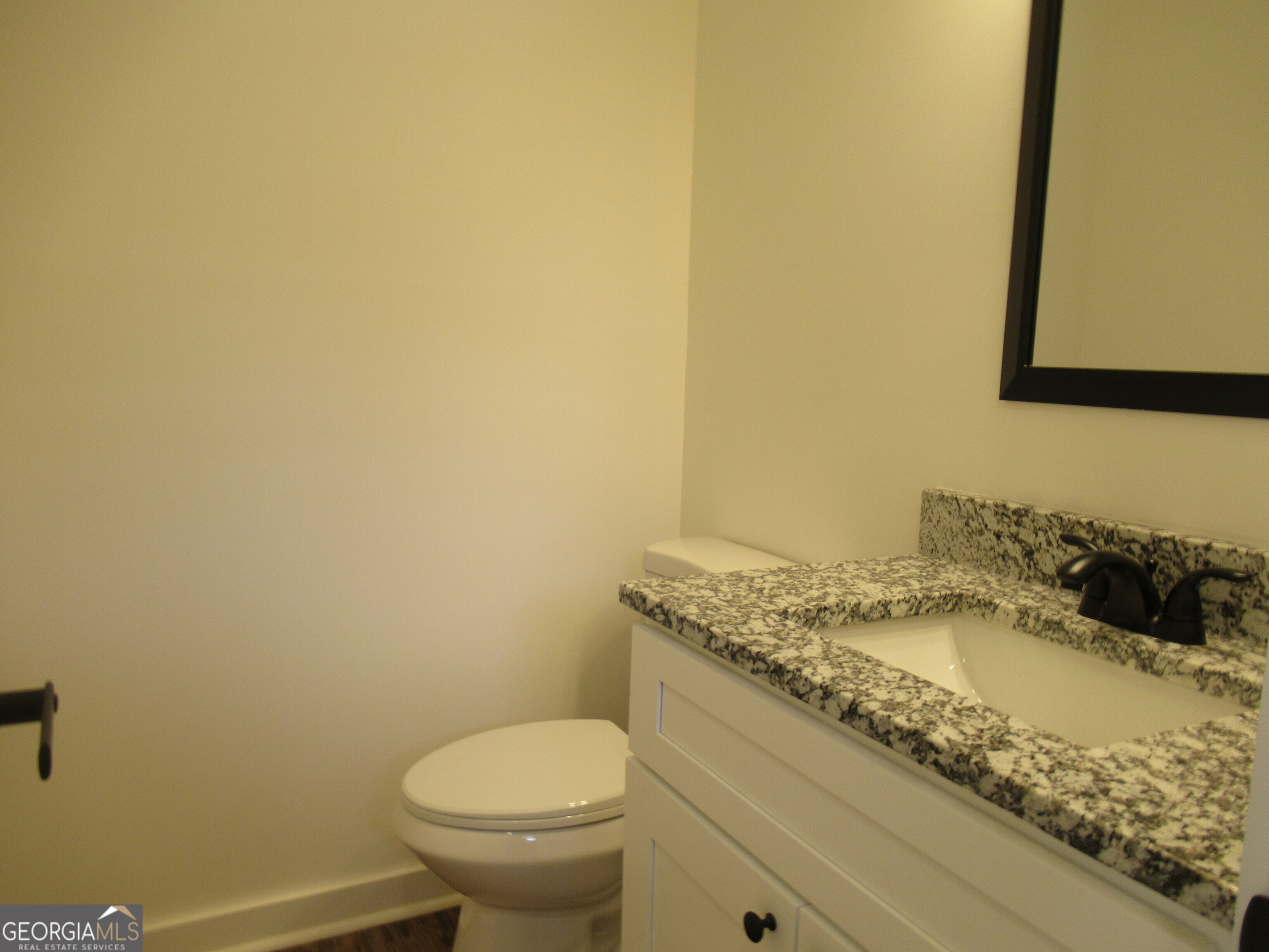 765 Old Kerns Road Dawsonville, GA 30534 - Photo 19 of 36 a bathroom with a granite countertop toilet and sink