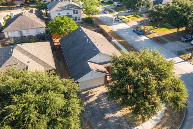 an aerial view of a house with a swimming pool