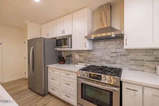 a kitchen with sink a window and cabinets