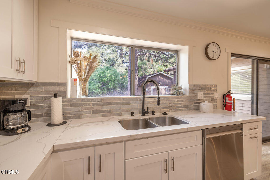 851 Pine Knot Avenue Big Bear Lake, CA 92315 - Photo 13 of 27 a kitchen with sink a window and cabinets