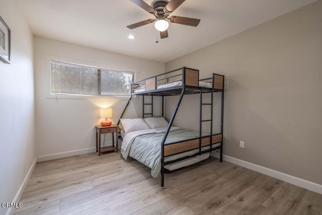 851 Pine Knot Avenue Big Bear Lake, CA 92315 - Photo 17 of 27 a bedroom with a bed and a chandelier fan