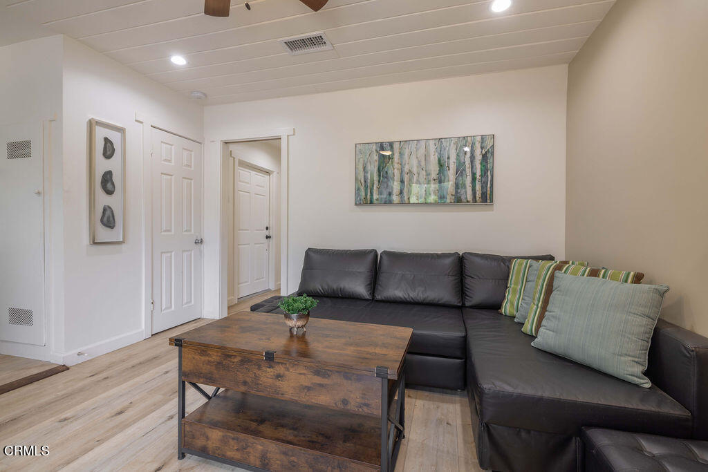 851 Pine Knot Avenue Big Bear Lake, CA 92315 - Photo 25 of 27 a living room with furniture and wooden floor