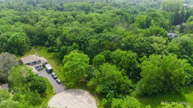 an aerial view of a house with yard