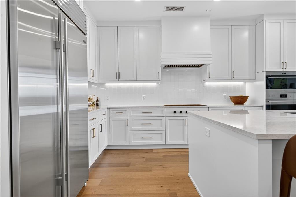 2520 Peachtree Road Northwest, Unit 903 Atlanta, GA 30305 - Photo 11 of 62 a kitchen with white cabinets and refrigerator