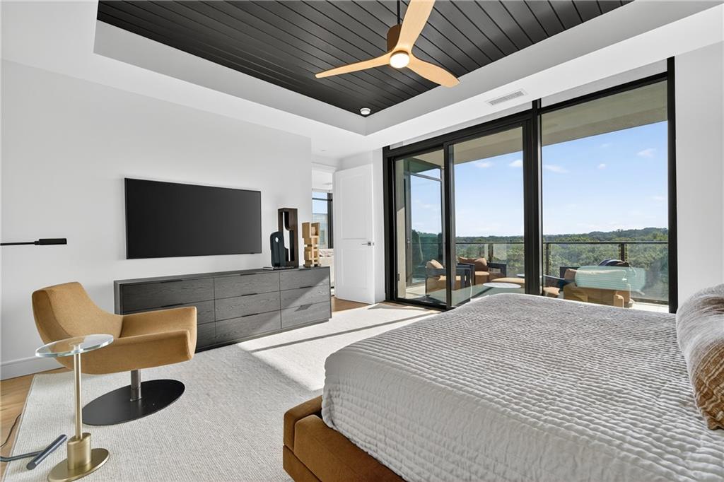 2520 Peachtree Road Northwest, Unit 903 Atlanta, GA 30305 - Photo 20 of 62 a bedroom with furniture a large window and a flat screen tv